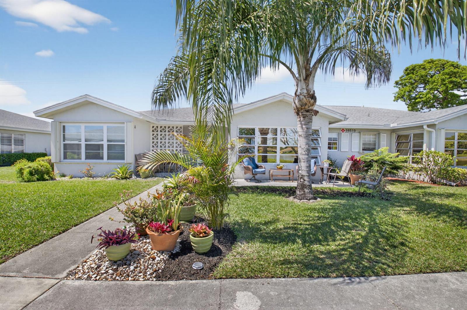 A single-story house exterior features a palm tree, a small patio, and a landscaped yard — 14519 Canalview Drive # B, Delray Beach FL 33484, DELRAY BEACH, FL
