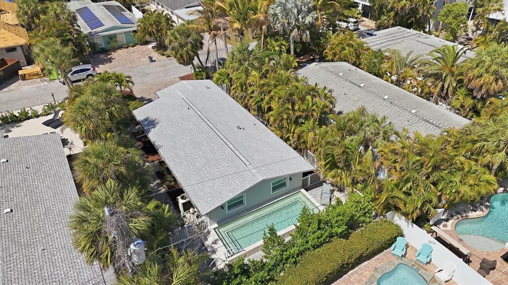An aerial view shows a house with a gray roof and a rectangular swimming pool — 5803 DE PALMAS AVENUE, HOLMES BEACH, FL