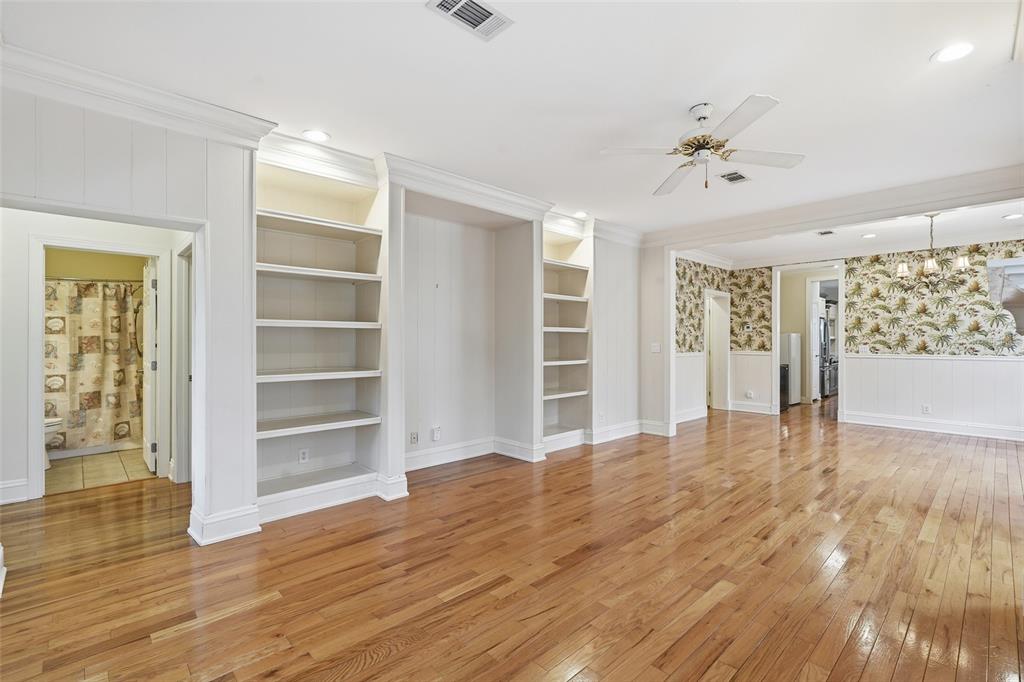 A living room features hardwood floors, built-in shelving, and an adjacent bathroom and kitchen — 11604 SE SHELFER AVENUE, ARCADIA, FL