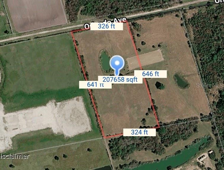 This is an aerial map showing a rectangular plot of land with a small pond — 0 ORLANDO AVENUE, MIMS, FL