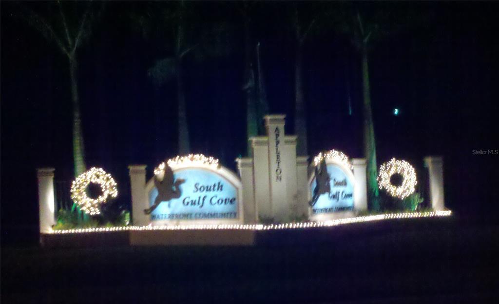 The illuminated entrance sign for the South Gulf Cove waterfront community at night — 14332 ARTESIA AVENUE, PORT CHARLOTTE, FL