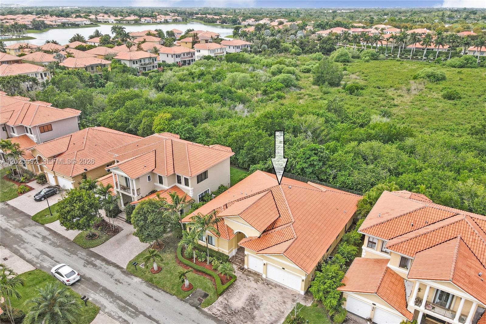 An aerial view shows a suburban house with a red tile roof and a driveway — CUTLER BAY, FL