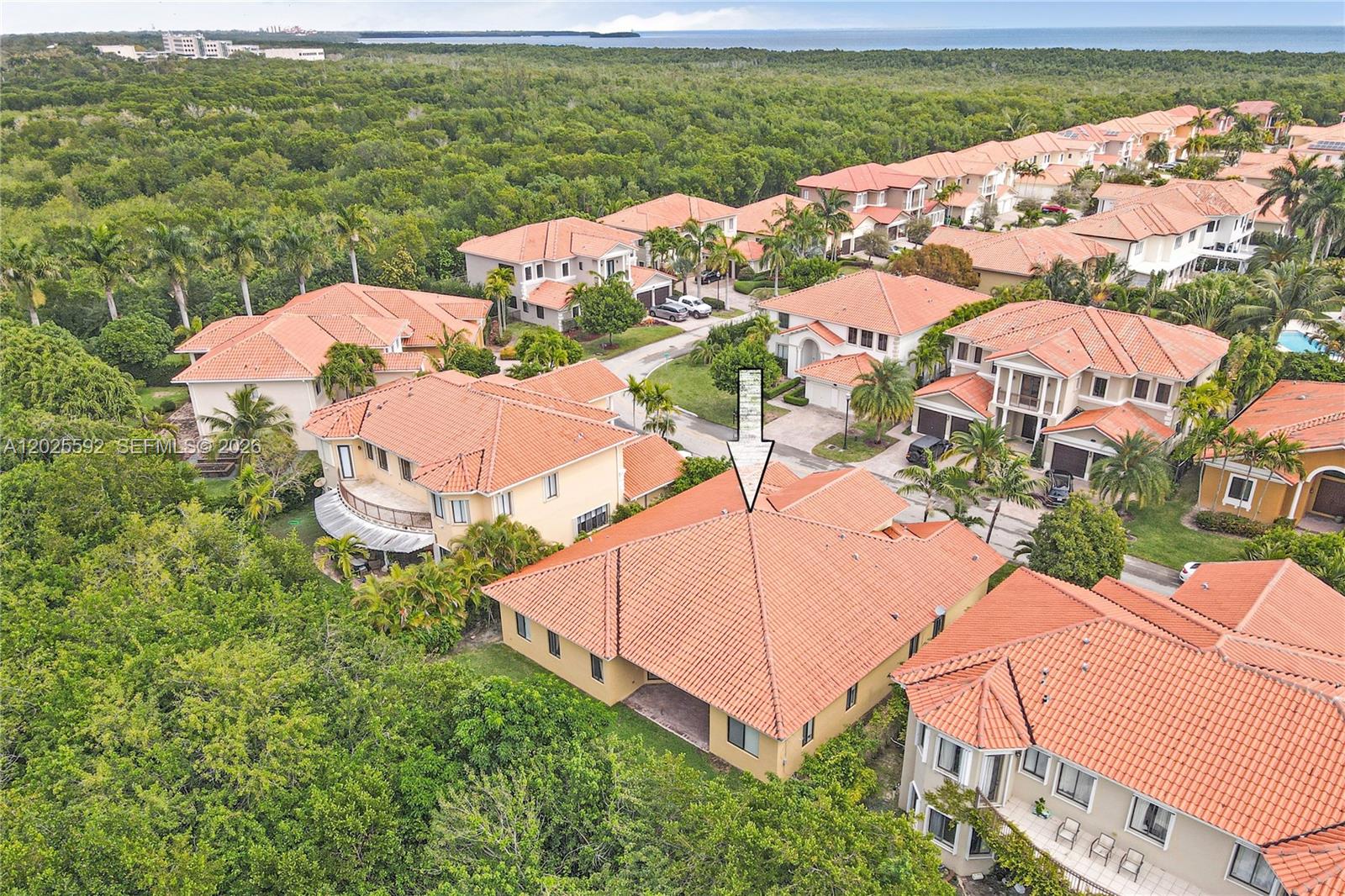 An aerial view shows a residential neighborhood with houses featuring orange tile roofs — CUTLER BAY, FL