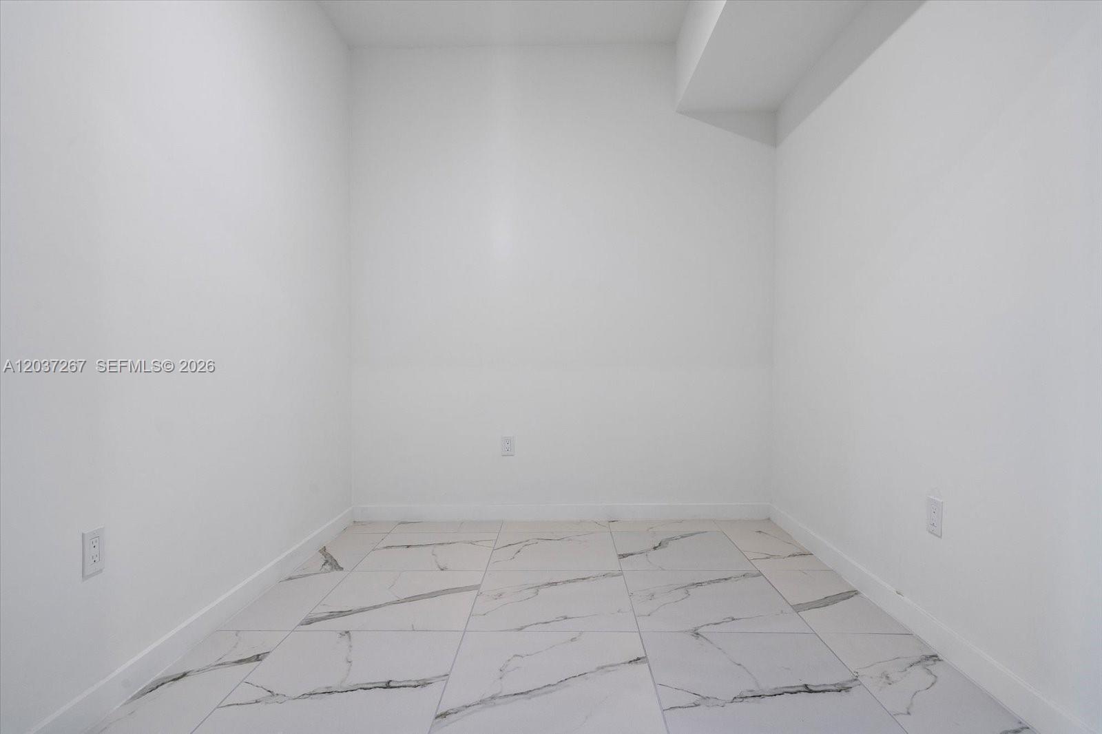 An empty room features white walls, a soffit, and white marble-patterned tile flooring — 420 SW 7th Ave # 204, Miami FL 33130, MIAMI, FL