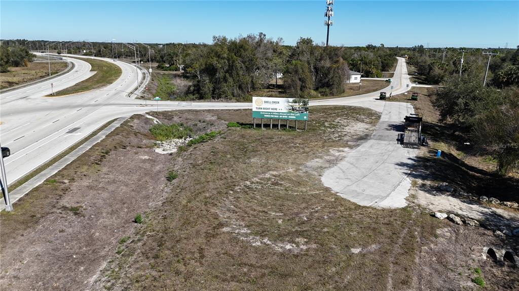 An aerial view shows a vacant lot with a billboard near a highway intersection — 4224 DUNCAN ROAD, PUNTA GORDA, FL