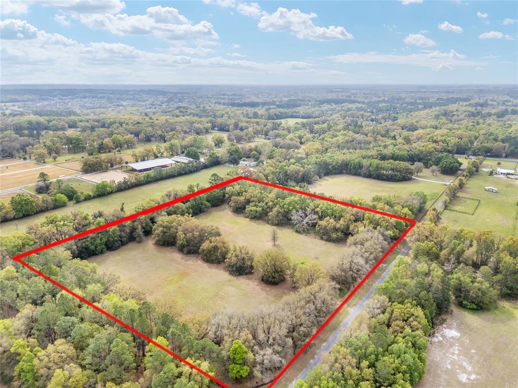 An aerial view shows a large, rectangular plot of land outlined in red — 3595 NW 156TH DRIVE, NEWBERRY, FL