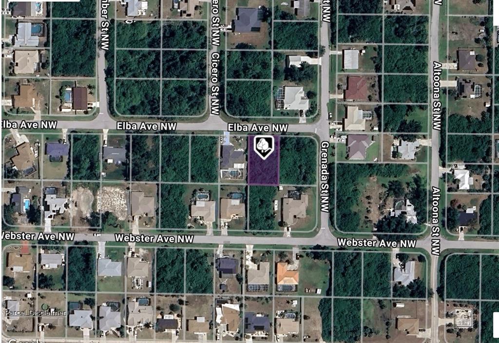 This aerial map shows a vacant residential lot highlighted in purple near a street intersection — 943 ELBA AVENUE NW, PORT CHARLOTTE, FL