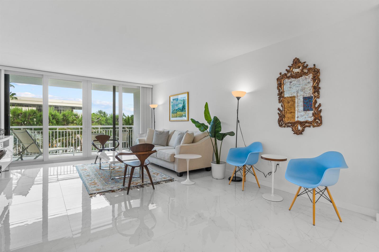 A bright living room features white tile floors, a beige sofa, and two blue chairs — 2780 S Ocean Boulevard # 306, Palm Beach FL 33480, PALM BEACH, FL