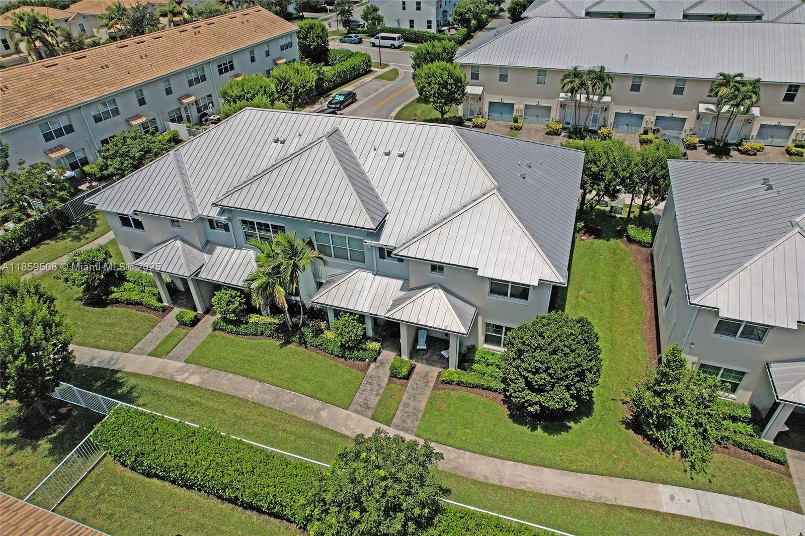 An aerial view shows a multi-unit residential building with a metal roof and landscaping — 4046 Long Leaf Ln, Hollywood FL 33021, HOLLYWOOD, FL