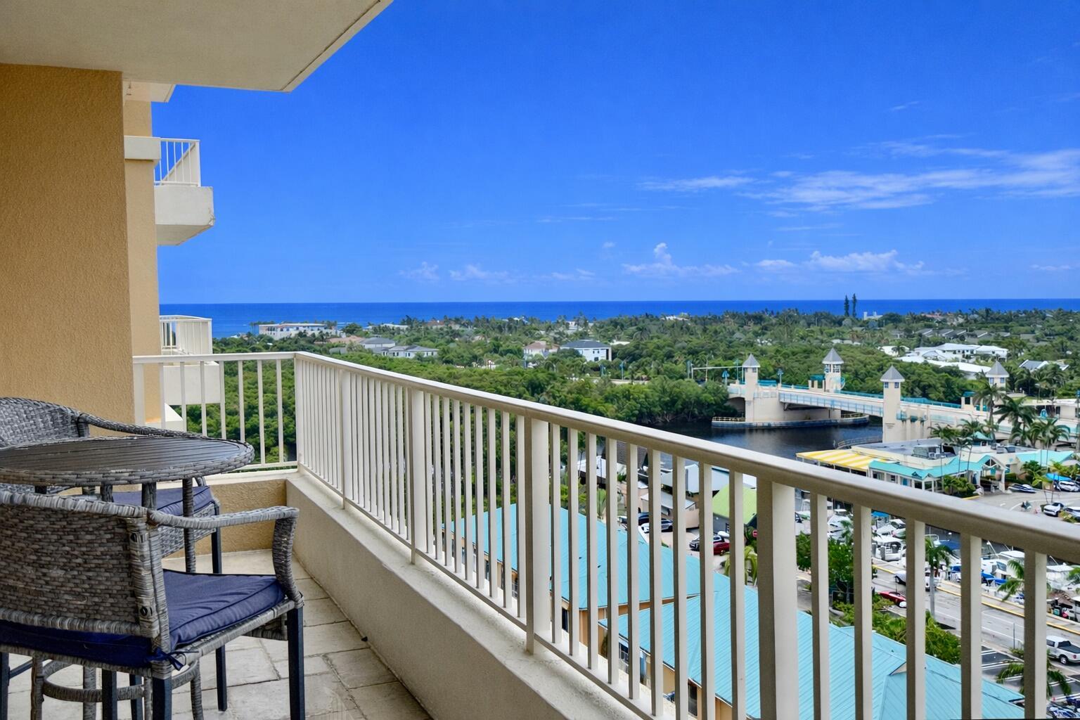 A balcony with patio furniture overlooks a waterway, a bridge, and the distant ocean — 700 E Boynton Beach Boulevard # 1203, Boynton Beach FL 33435, BOYNTON BEACH, FL