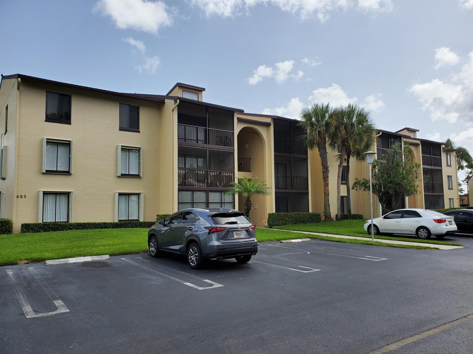 A three-story apartment building with a parking lot and palm trees in front — 603 Sea Pine Way # B2, FL 33415, FL
