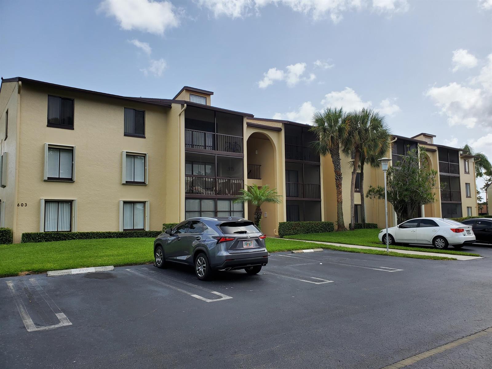 A three-story apartment building with a parking lot and palm trees in front — 603 Sea Pine Way # B2, FL 33415, FL