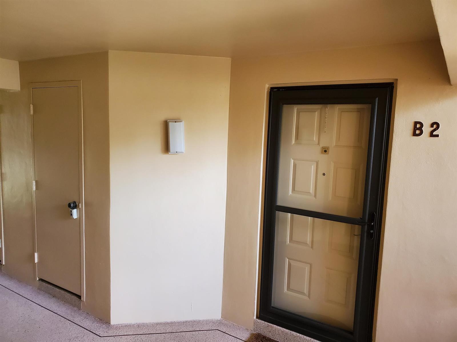 A beige hallway features a door labeled B2 and a smaller adjacent utility door — 603 Sea Pine Way # B2, FL 33415, FL
