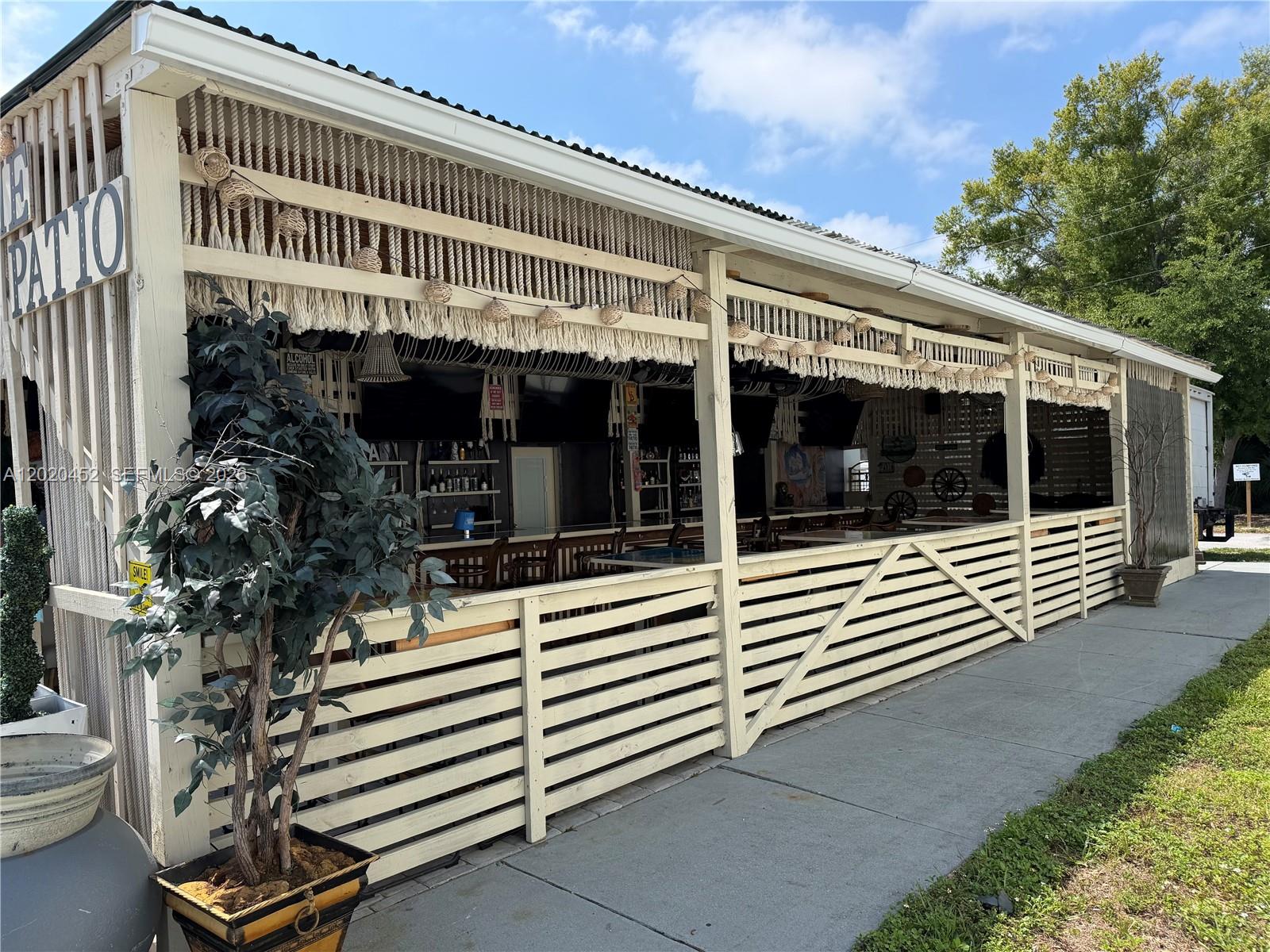 An outdoor bar area features a covered patio with wooden slat railings and rope decor — 29168 N US HWY 19, Clearwater FL 33761, CLEARWATER, FL