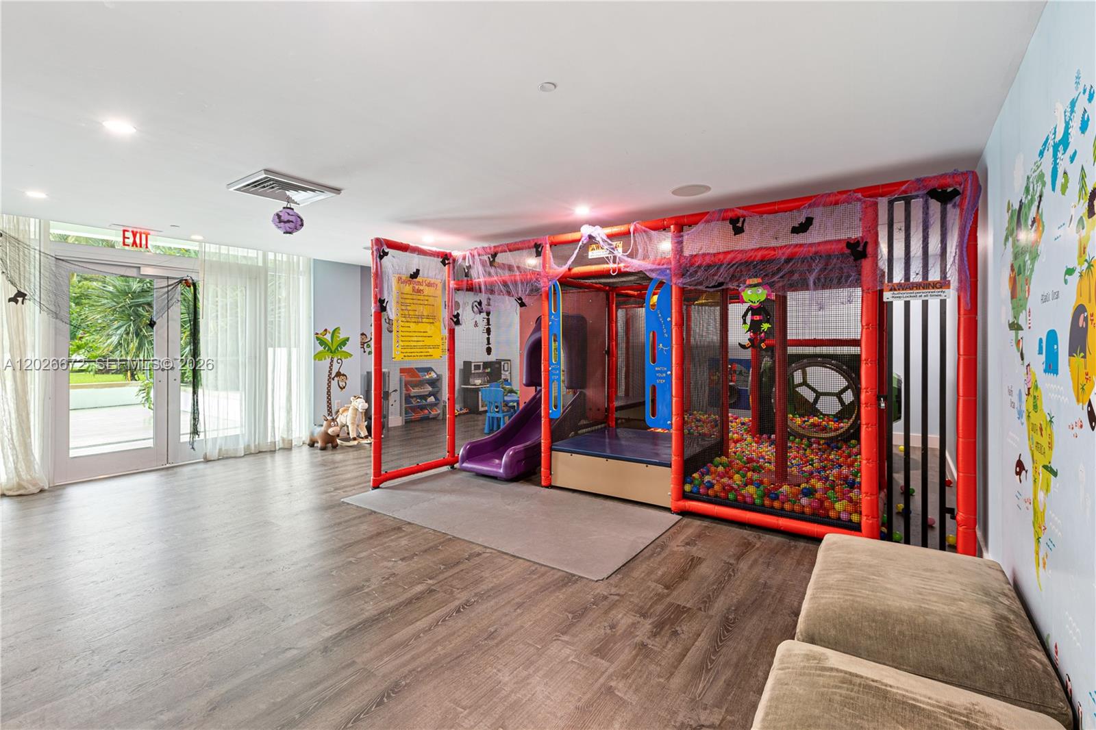 A playroom features a large indoor jungle gym with a ball pit and slide — 951 Brickell Ave # 1801, Miami FL 33131, MIAMI, FL