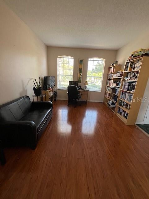 A home office with a black sofa, a desk, and a tall wooden bookshelf — 806 LOST GROVE CIRCLE, WINTER GARDEN, FL