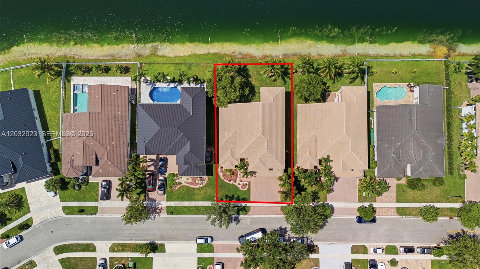An aerial view shows a residential property with a red outline situated along a lake — 18543 SW 49th St, Miramar FL 33029, MIRAMAR, FL