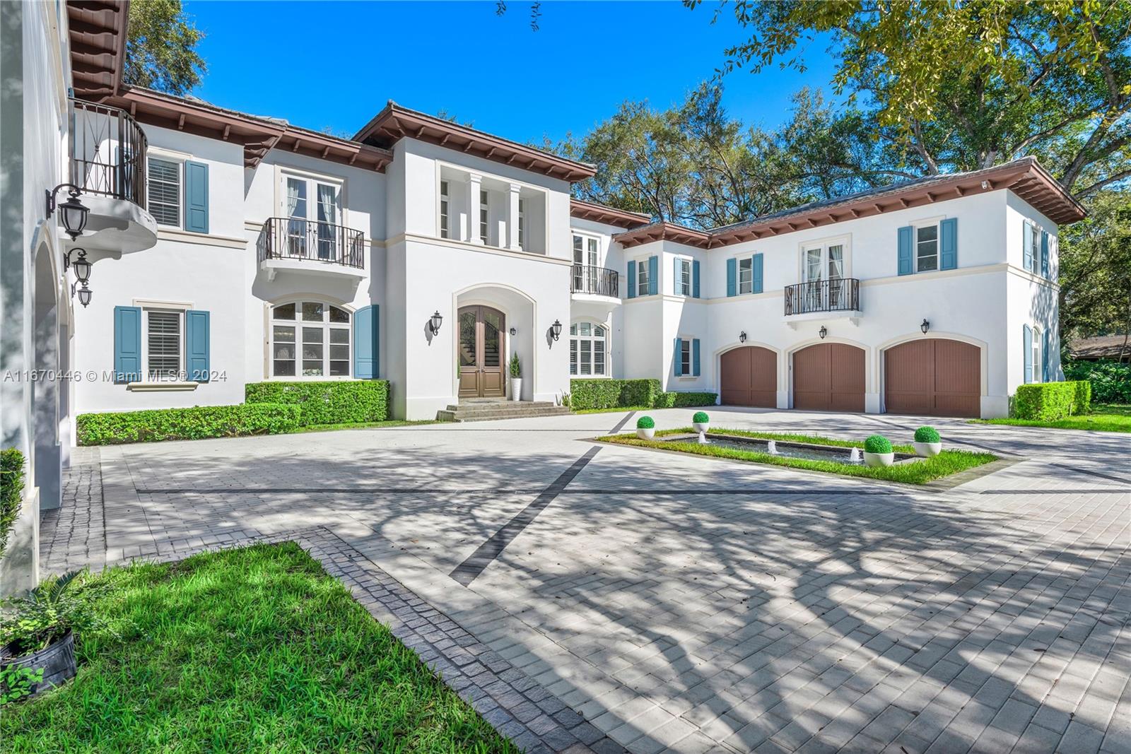 A large white two-story Mediterranean-style house features a paved driveway, three-car garage, and fountain — 5225 Fairchild Way, Coral Gables FL 33156, CORAL GABLES, FL
