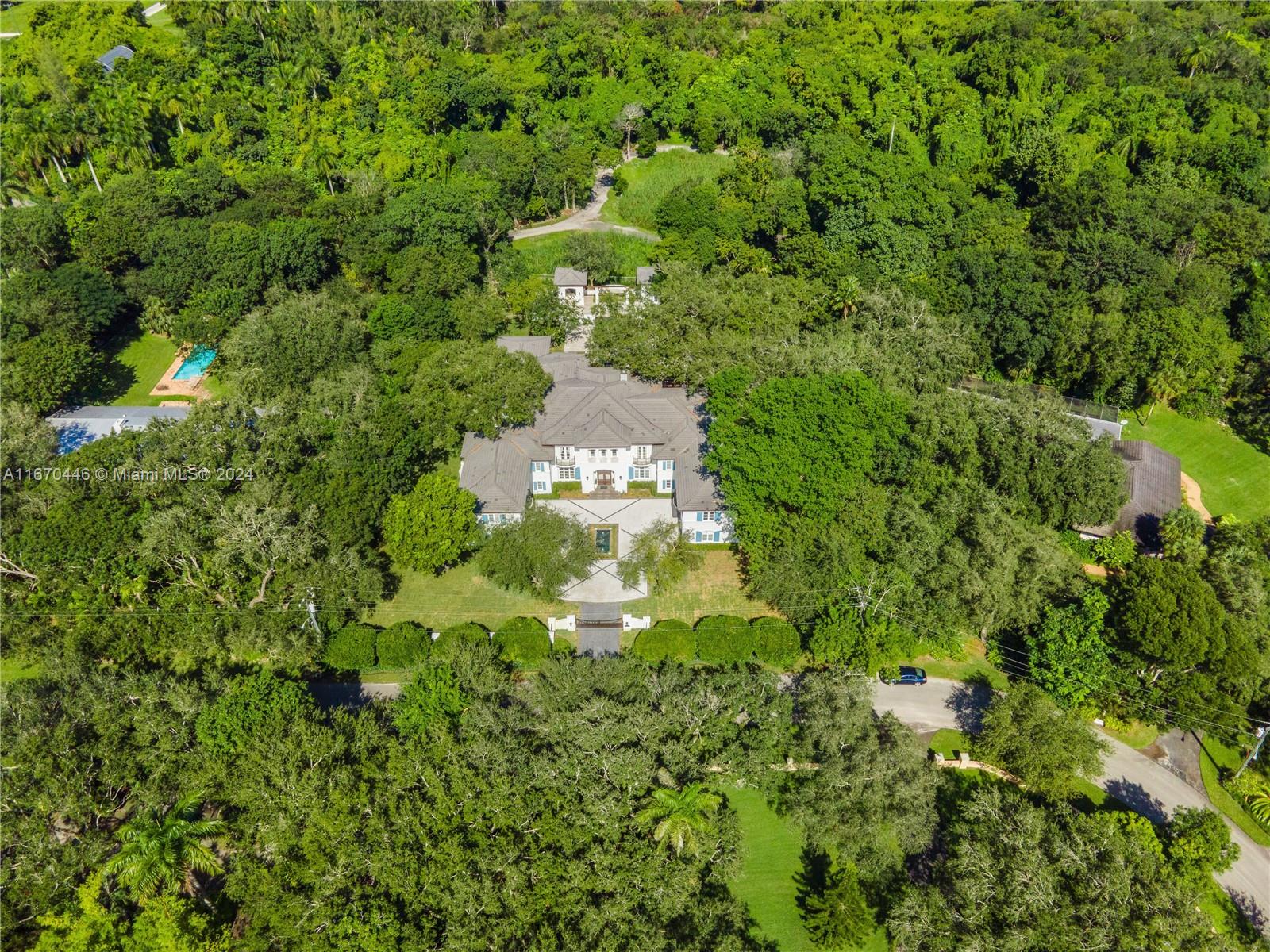 An aerial view shows a large house surrounded by dense trees and a swimming pool — 5225 Fairchild Way, Coral Gables FL 33156, CORAL GABLES, FL