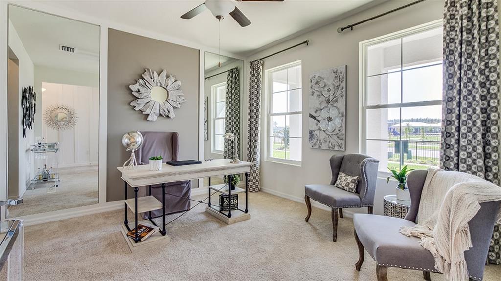 A home office features a desk, two armchairs, mirrored walls, and large windows with curtains — 36207 HILLRIDGE TRAIL, ZEPHYRHILLS, FL