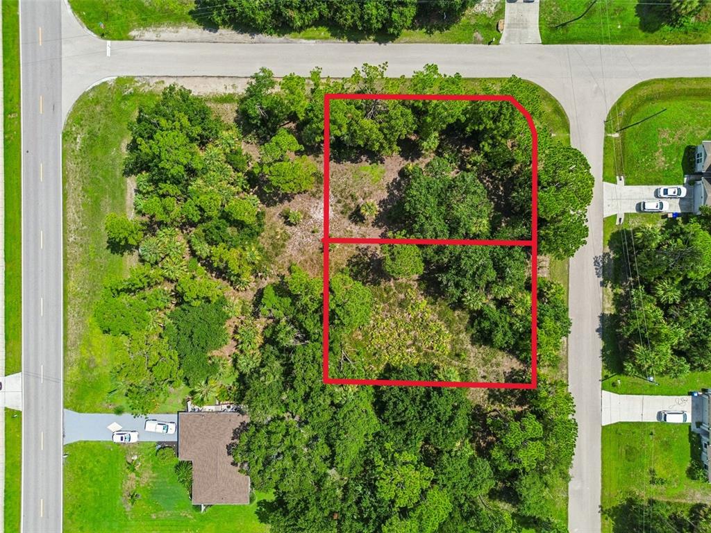 An aerial view shows two adjacent, wooded, undeveloped residential lots outlined in red — 15 HEATHER TERRACE, NORTH PORT, FL
