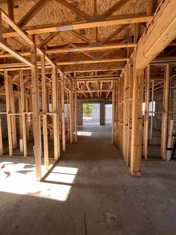 An interior view of a house under construction showing exposed wood framing and concrete floors — 485 11TH AVENUE N, ST PETERSBURG, FL