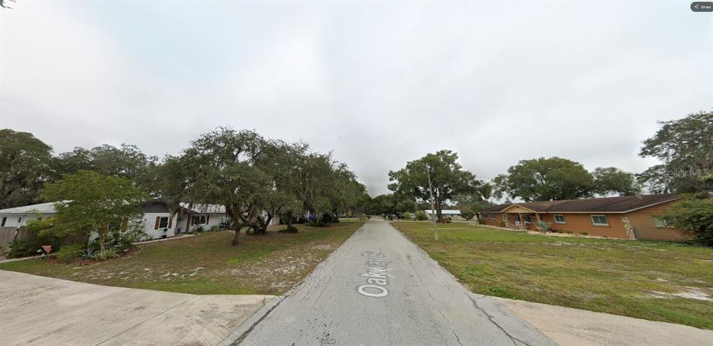 A residential street view shows houses on both sides with trees and a paved road — OAKWAY DRIVE, LAKELAND, FL