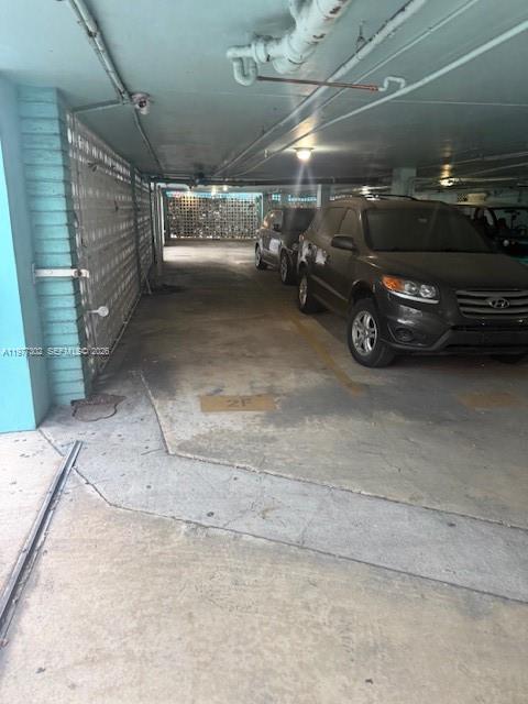 A covered parking garage features concrete flooring and two parked SUVs — 701 Collins Ave # 2B, Miami Beach FL 33139, MIAMI BEACH, FL