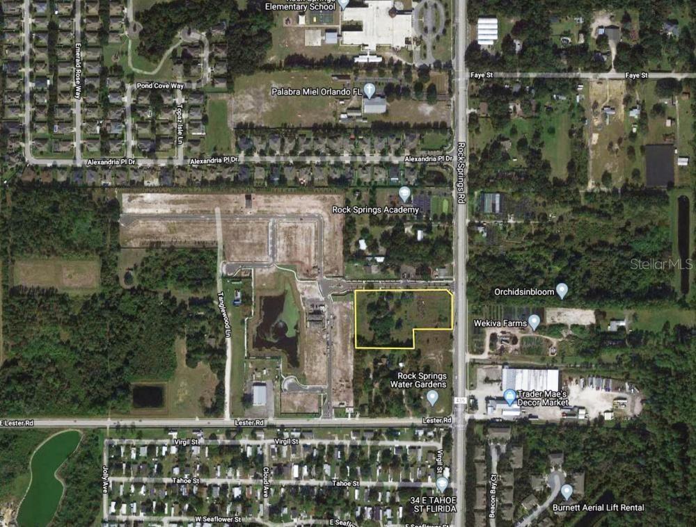 This aerial map shows a vacant, rectangular lot outlined in red near a road intersection — 2104 ROCK SPRINGS ROAD, APOPKA, FL