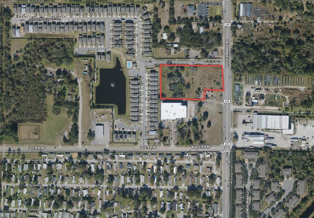 An aerial map view shows a vacant rectangular lot outlined in red near a road — 2104 ROCK SPRINGS ROAD, APOPKA, FL