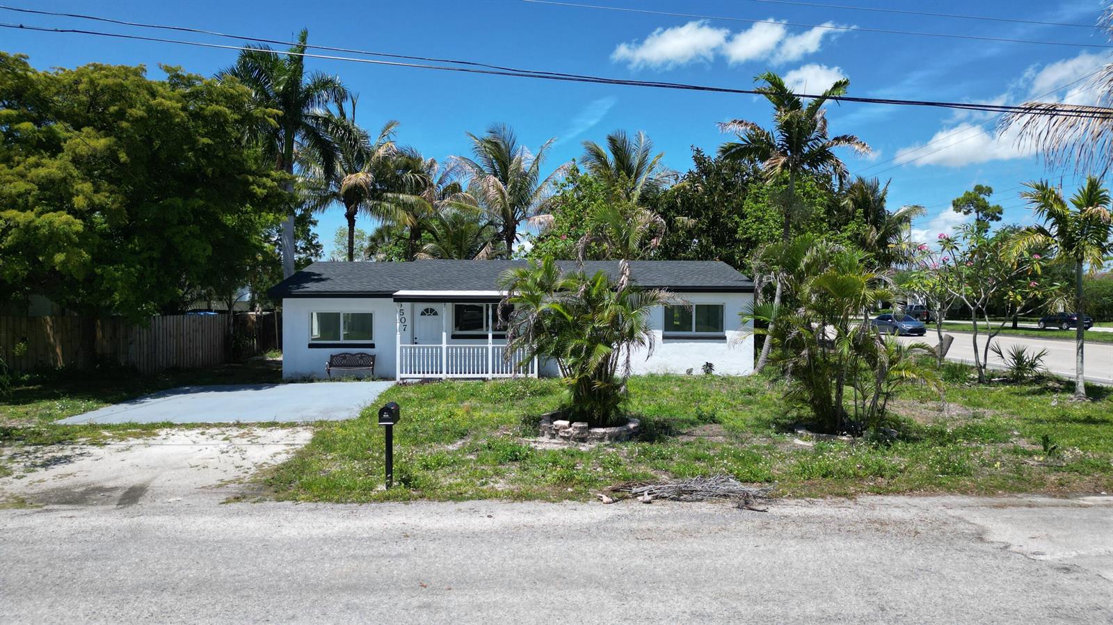 A single-story white house with a dark roof and a front porch sits on a lot — 6507 Alexander Road, West Palm Beach FL 33413, WEST PALM BEACH, FL