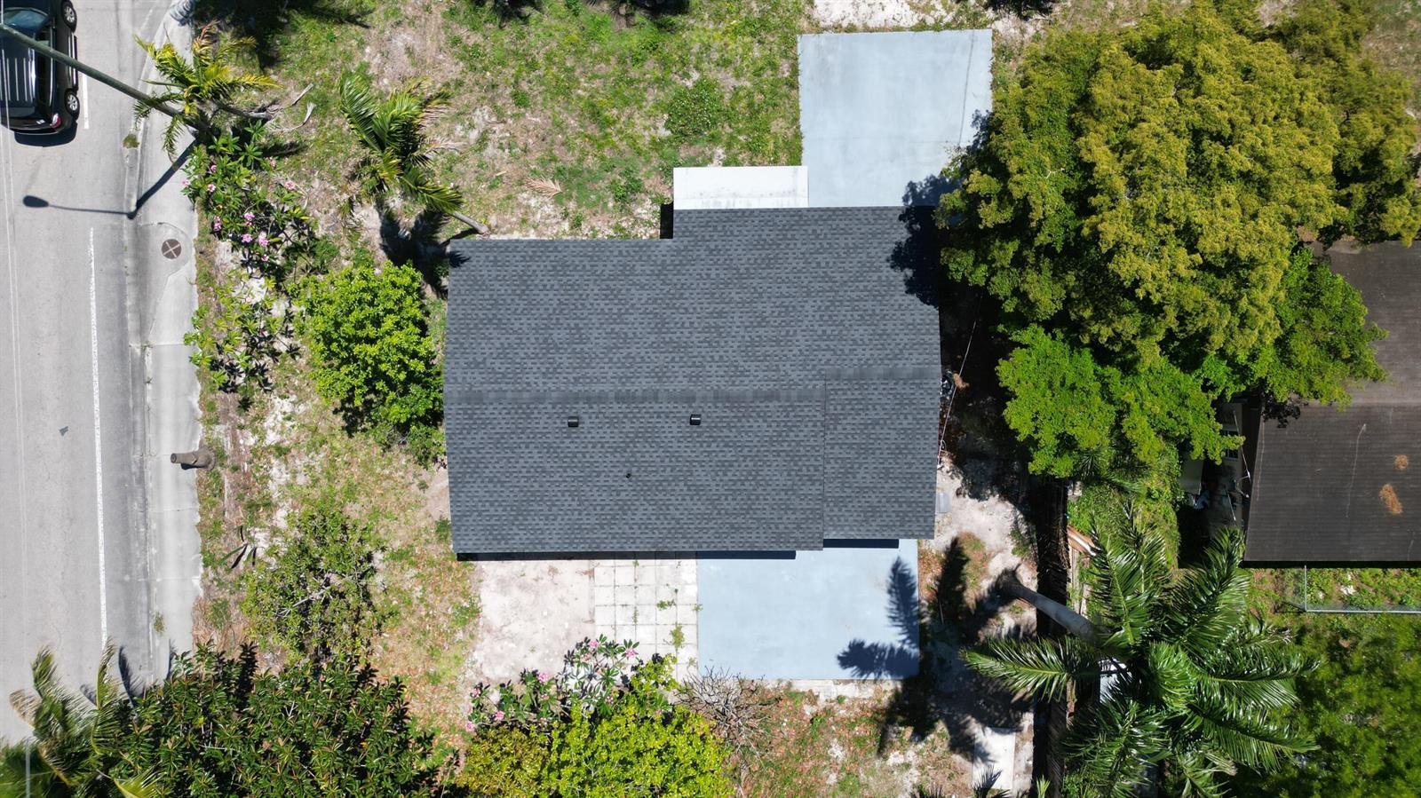 An aerial view shows a house with a dark shingled roof and two concrete pads — 6507 Alexander Road, West Palm Beach FL 33413, WEST PALM BEACH, FL
