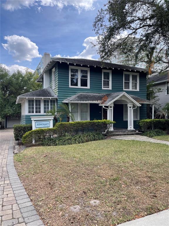 A two-story teal house with a front porch and a paved driveway — 612 E CENTRAL BOULEVARD, ORLANDO, FL