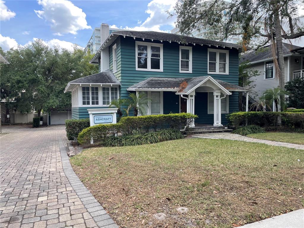 A two-story teal house with a brick driveway and a front porch — 612 E CENTRAL BOULEVARD, ORLANDO, FL