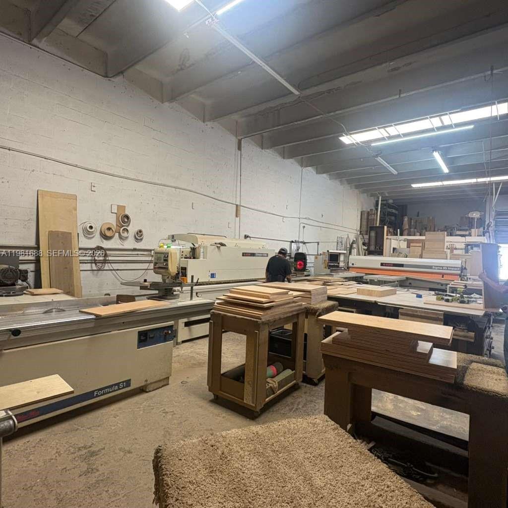 This is a woodworking shop featuring industrial machinery, workbenches, and stacks of lumber — 2683 76, Hialeah FL 33016, HIALEAH, FL