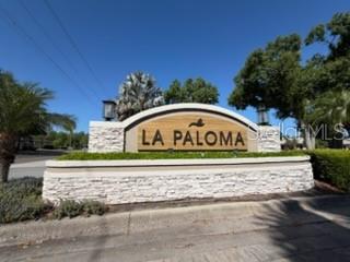 A stone-faced monument sign for La Paloma stands at the entrance of a residential community — 3918 GAVIOTA DRIVE, SUN CITY CENTER, FL
