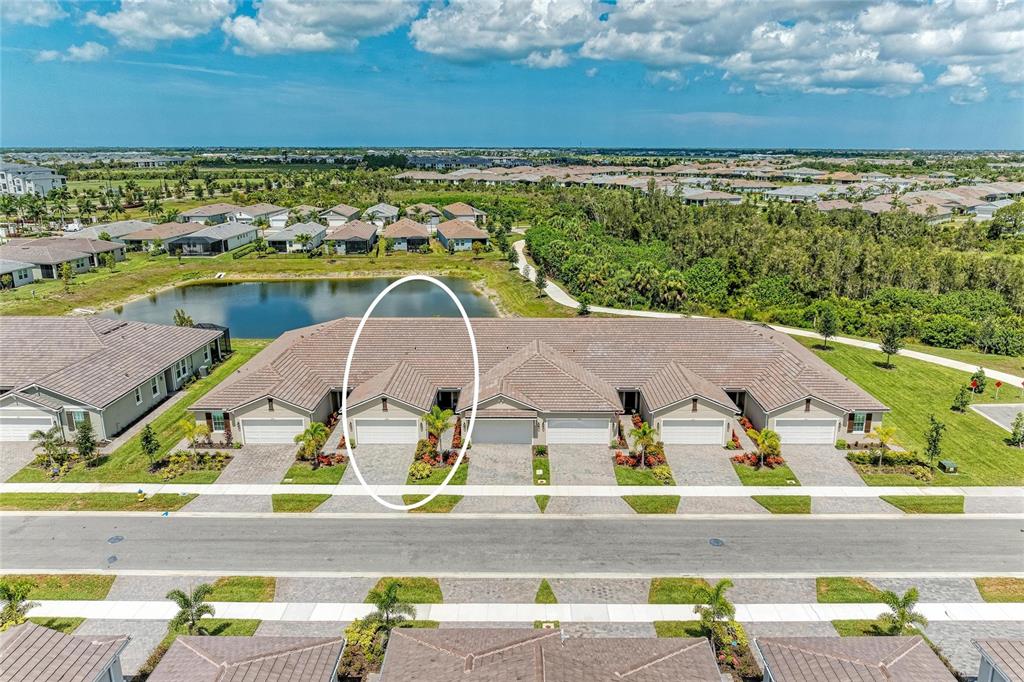 An aerial view shows a row of attached houses with tiled roofs and paved driveways — 17827 STILLNESS COURT, VENICE, FL