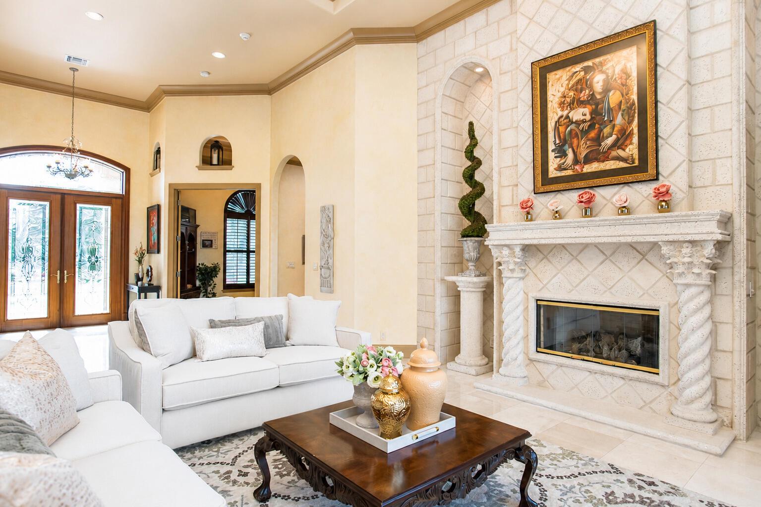 A living room features a stone fireplace, white sofas, and a wooden coffee table — 2804 Bent Pine Drive, Fort Pierce FL 34951, FORT PIERCE, FL