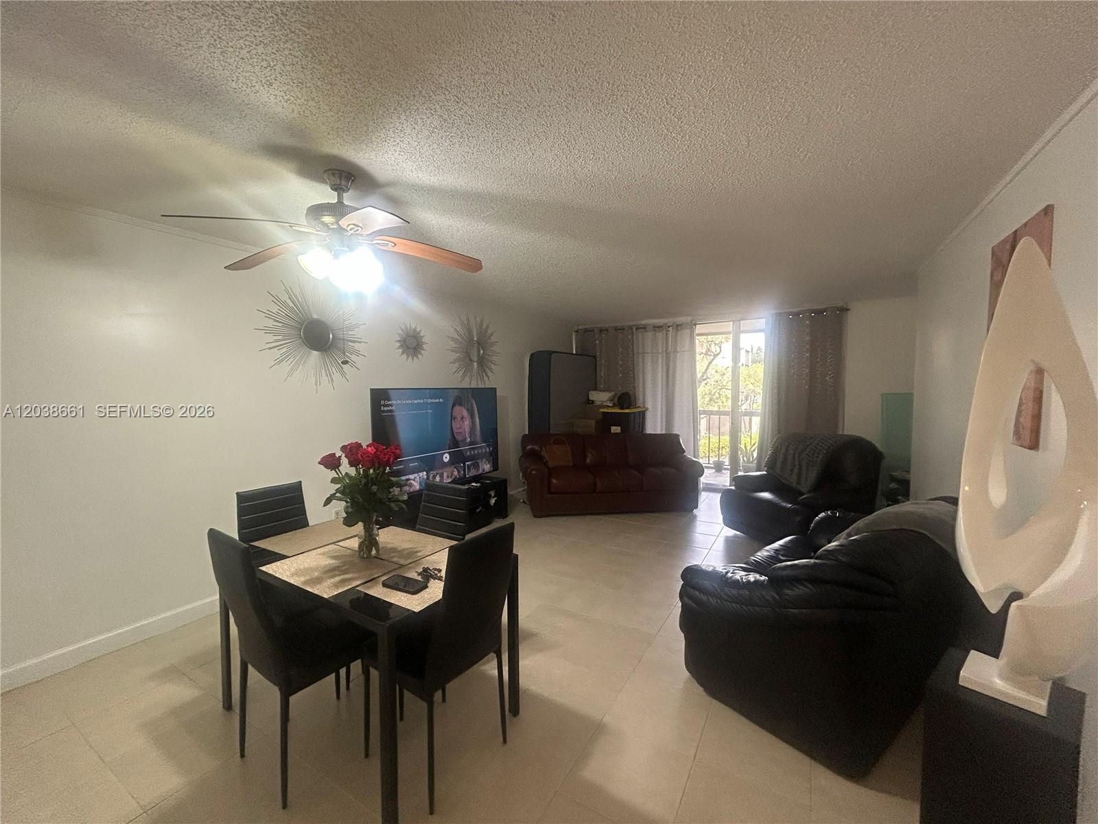 A living and dining area features tile floors, a ceiling fan, and leather furniture — 10875 SW 112th Ave # 203, Miami FL 33176, MIAMI, FL