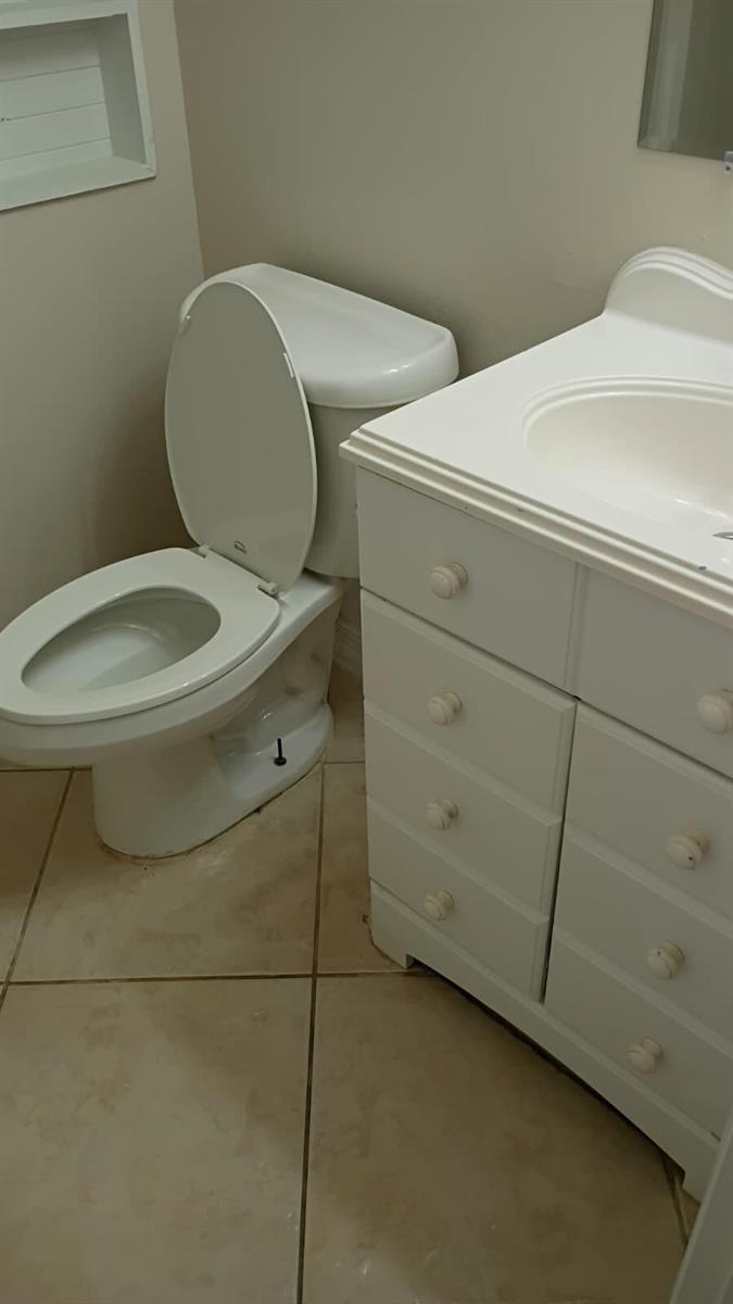 A bathroom features a white vanity with a sink next to a white toilet — 1205 S Flagler Avenue # 405, Pompano Beach FL 33060, POMPANO BEACH, FL