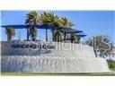 A concrete monument sign for Winding Ridge features palm trees and blue shade structures — 32588 TREE OF LIFE AVENUE, WESLEY CHAPEL, FL