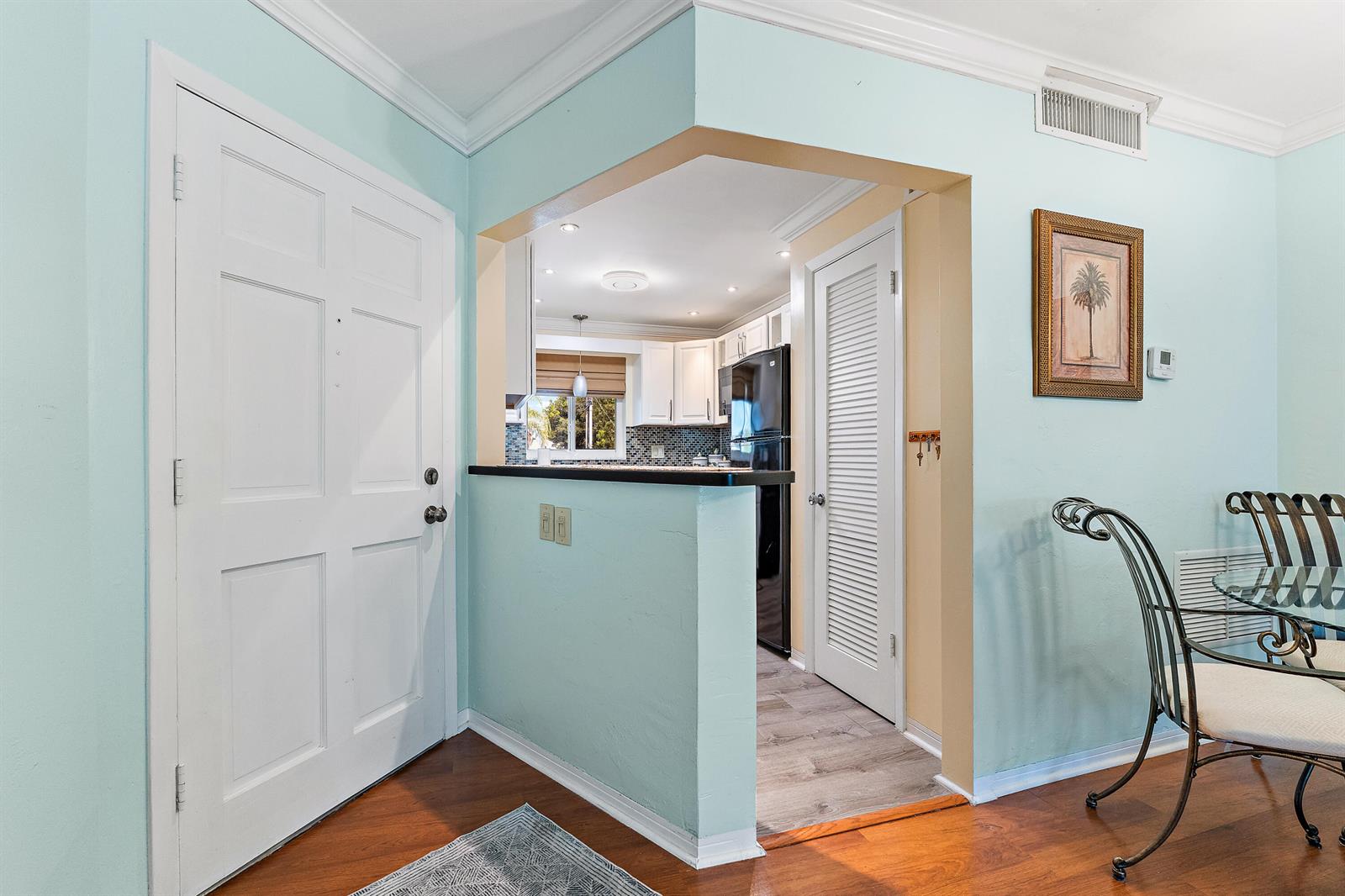 A view from an entryway looking into a kitchen with a pass-through counter — 4 Westwood Avenue # 204, Jupiter FL 33469, JUPITER, FL