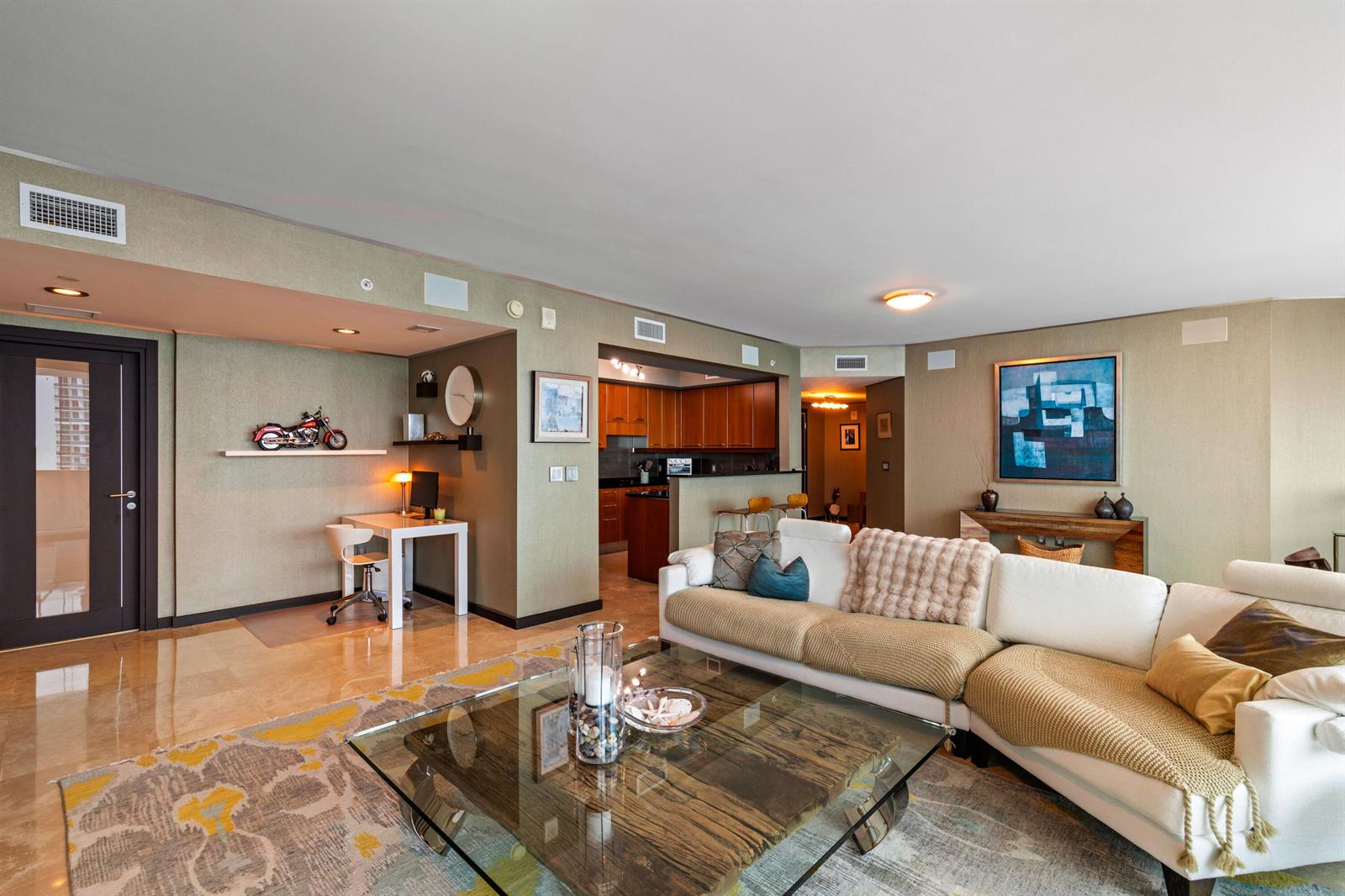 A living room features a white sectional sofa, a glass coffee table, and a desk area — 3101 S Ocean Drive # 3105, Hollywood FL 33019, HOLLYWOOD, FL