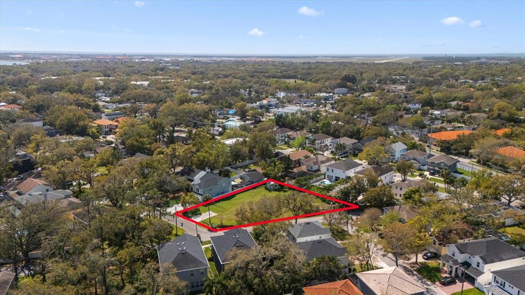 An aerial view shows a vacant, rectangular lot outlined in red within a residential neighborhood — 5801 S 2ND STREET, TAMPA, FL