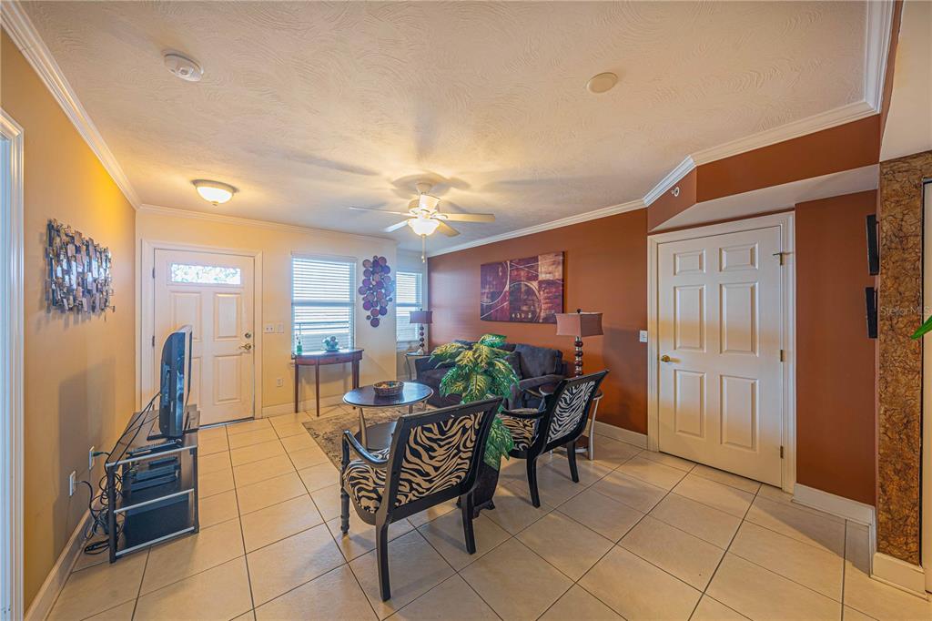 A living room with tile floors, a ceiling fan, and a sofa with two chairs — 3315 S ATLANTIC AVENUE UNIT 1707, DAYTONA BEACH SHORES, FL