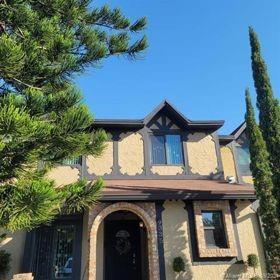 A two-story house with tan stucco walls, dark brown trim, and an arched front entrance — 9335 NW 45th Street # 9335, Sunrise FL 33351, SUNRISE, FL