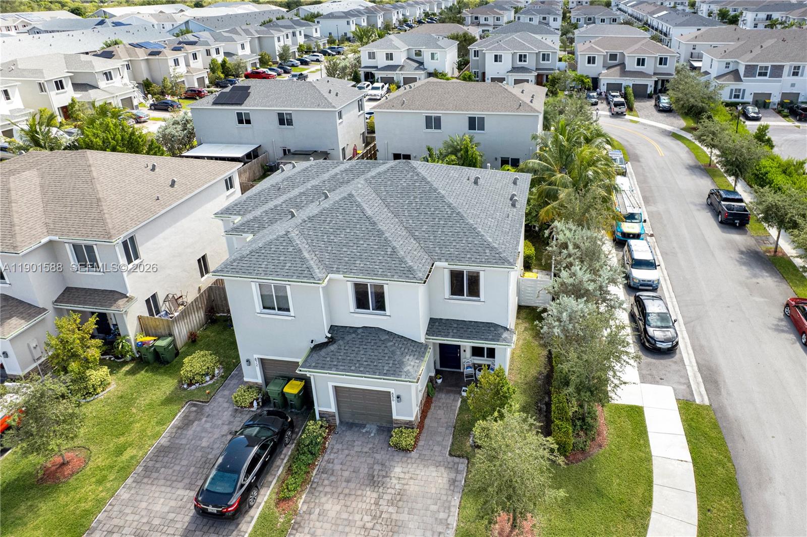 An aerial view shows a two-story suburban house with a gray roof and driveway — 856 SE 16th Ct, Homestead FL 33034, HOMESTEAD, FL