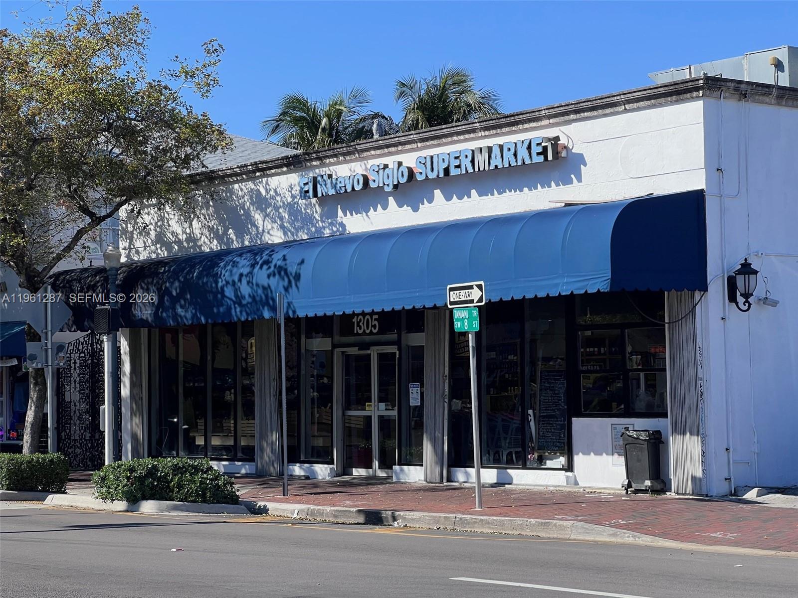 A white commercial building with a blue awning and a supermarket sign on the exterior — 1305 SW 8th St, Miami FL 33135, MIAMI, FL