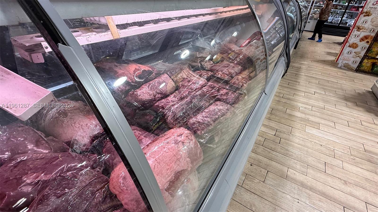 A refrigerated display case filled with various cuts of raw meat sits in a store — 1305 SW 8th St, Miami FL 33135, MIAMI, FL