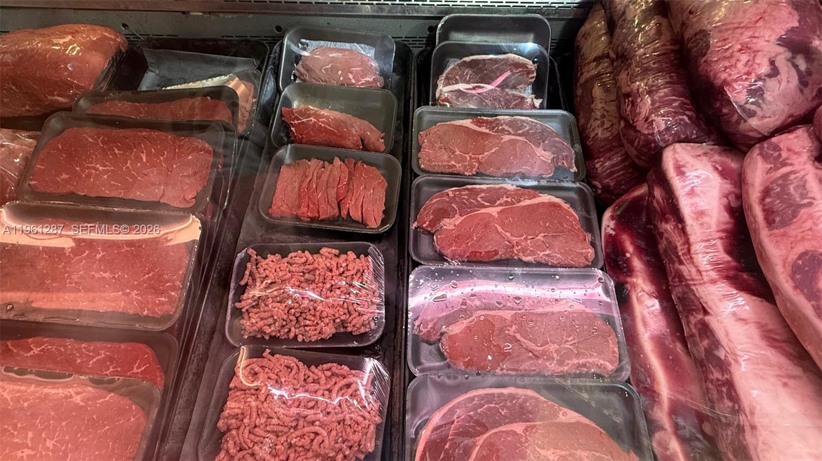 A display case contains various cuts of raw beef and ground meat — 1305 SW 8th St, Miami FL 33135, MIAMI, FL